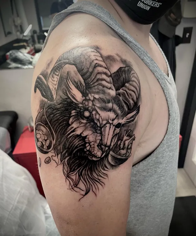 A horned creature with scales and an anatomical heart tattooed on an upper arm.
